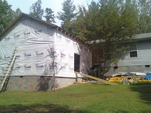 Tyvek wrapped gable on a new room addition beside an existing home in Pleasant Valley