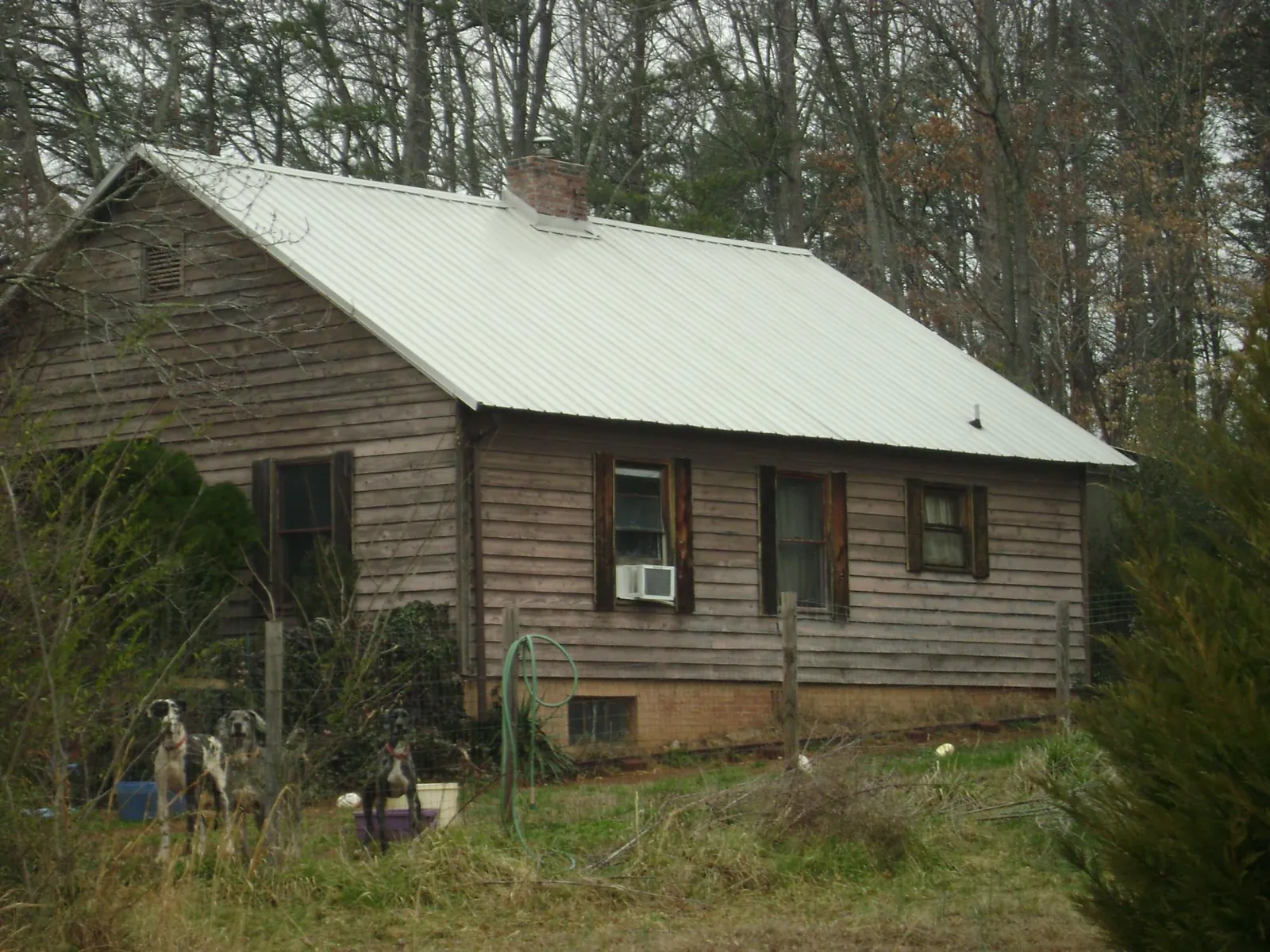 White metal roof on an old wood sided farmhouse, from a Metal Roof Installation job in Pleasant Valley